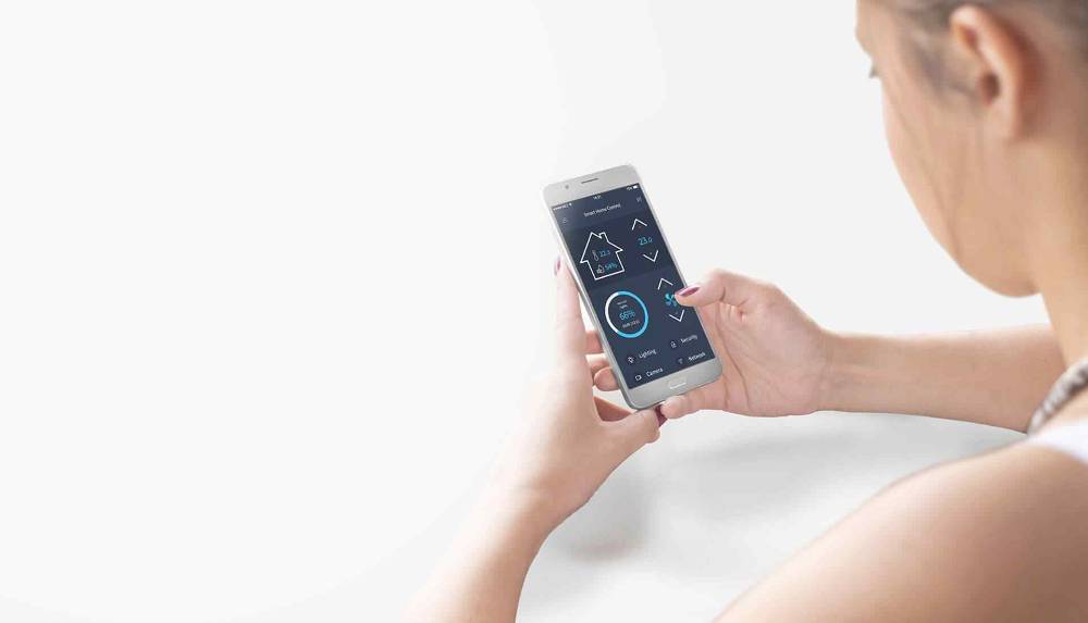 Homeowner adjusting a smart thermostat app